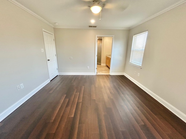 unfurnished room with ornamental molding, dark wood-type flooring, and ceiling fan