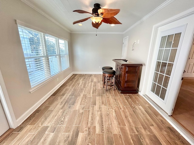 interior space featuring ceiling fan, ornamental molding, and light hardwood / wood-style floors