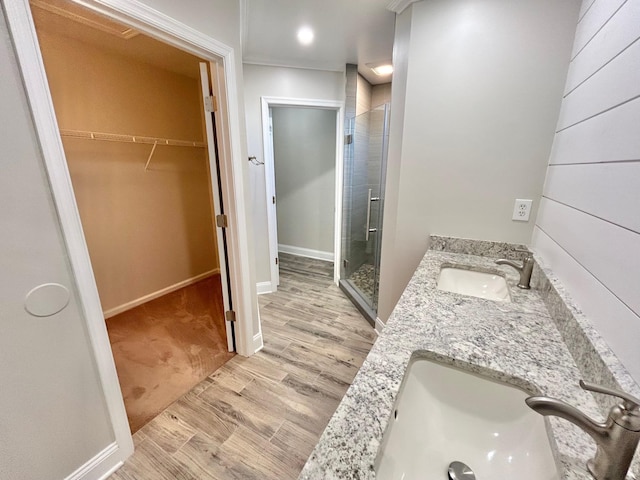 bathroom featuring vanity, hardwood / wood-style flooring, and walk in shower