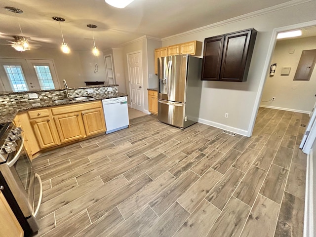 kitchen featuring dishwasher, pendant lighting, stainless steel fridge with ice dispenser, stove, and sink