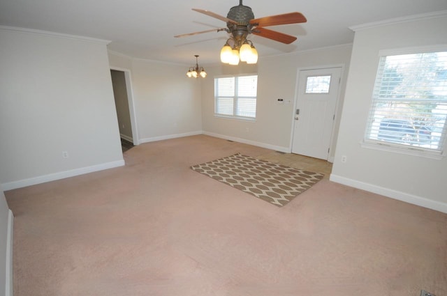 carpeted entrance foyer featuring ceiling fan with notable chandelier and ornamental molding