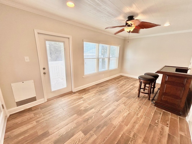 interior space featuring ceiling fan, crown molding, and hardwood / wood-style flooring