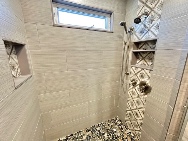 bathroom with a tile shower