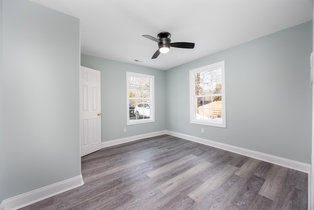 empty room with ceiling fan and dark wood-type flooring