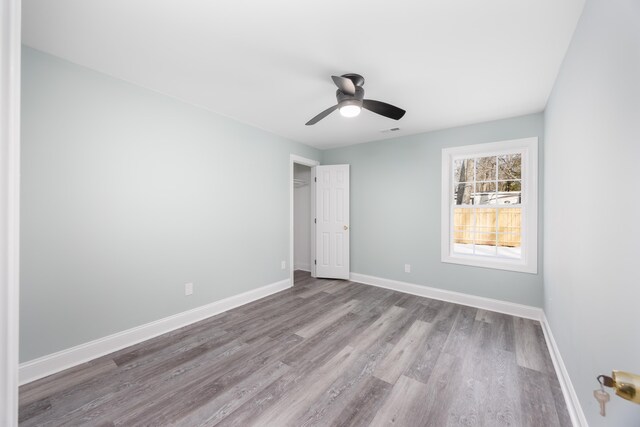 unfurnished bedroom with light hardwood / wood-style flooring and ceiling fan