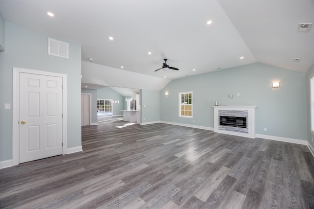 unfurnished living room with hardwood / wood-style flooring, vaulted ceiling, plenty of natural light, and ceiling fan