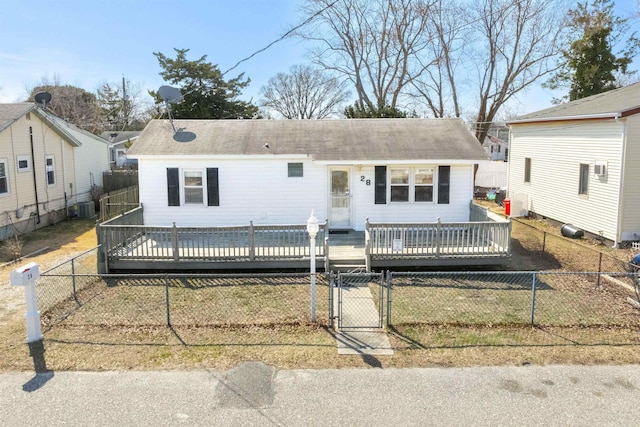 view of front of home with a gate, central AC unit, a fenced front yard, and a wooden deck