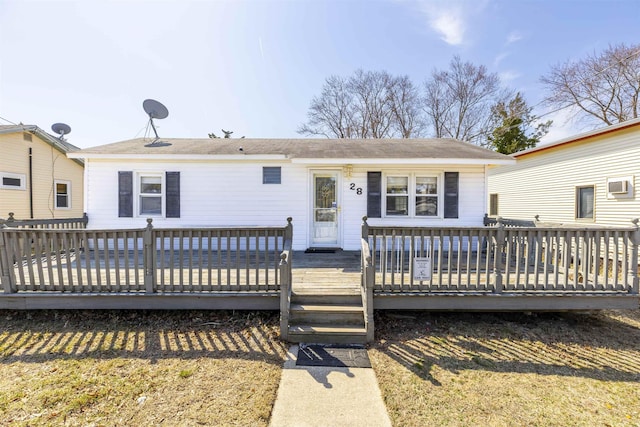 view of front facade with a deck and a front lawn