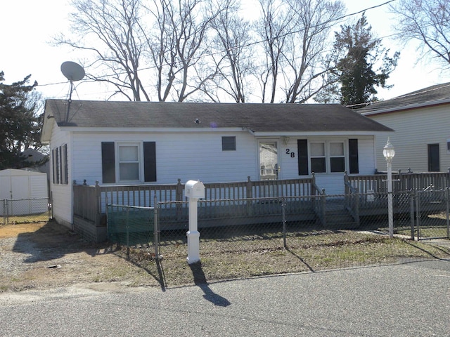 view of front of house featuring fence and a wooden deck