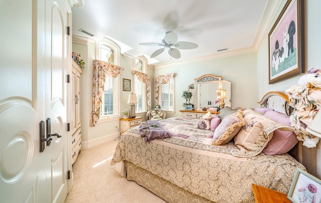 bedroom featuring ornamental molding, light colored carpet, and ceiling fan