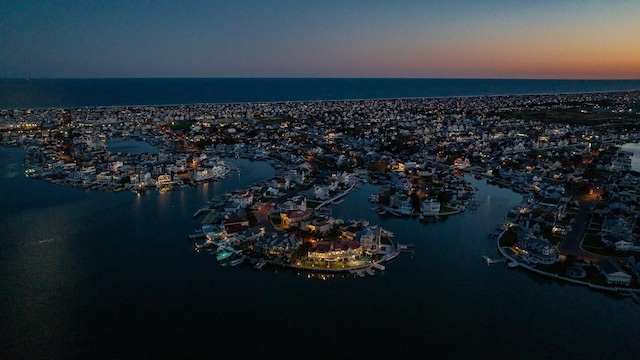 aerial view at dusk with a water view