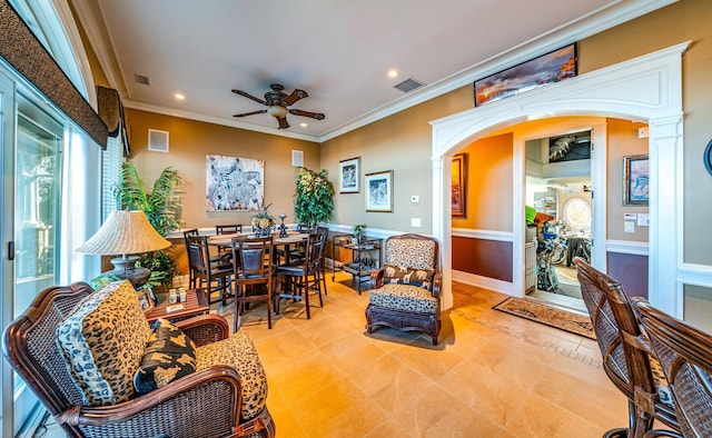 interior space with decorative columns and ceiling fan