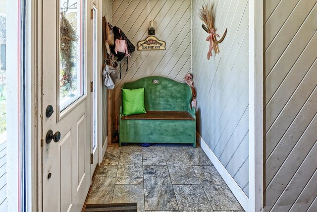 mudroom with wooden walls