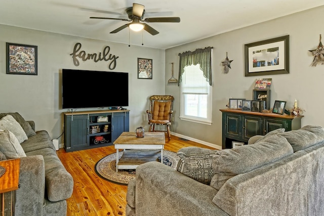 living room featuring baseboards, a ceiling fan, wood finished floors, and visible vents