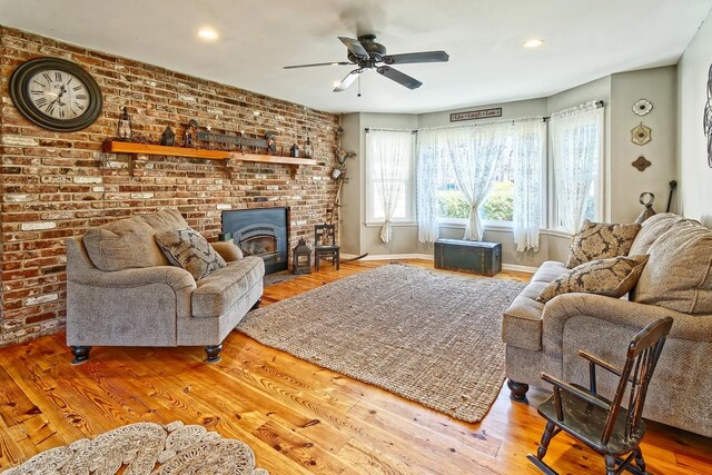 living area with wood finished floors, a ceiling fan, recessed lighting, and baseboards