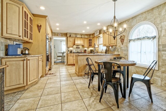 dining room with light tile patterned floors, recessed lighting, and a notable chandelier