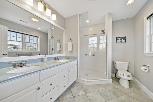 full bath featuring tile patterned floors, a sink, toilet, and a shower stall