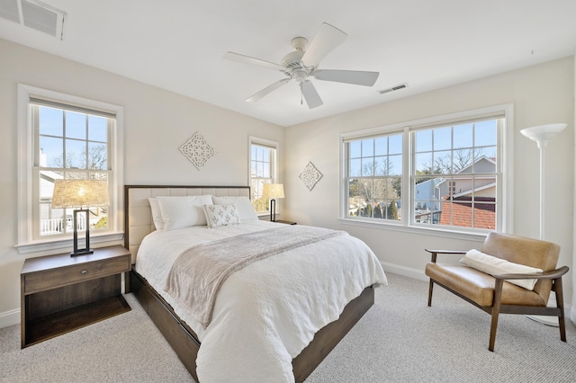 bedroom featuring carpet floors, baseboards, visible vents, and ceiling fan