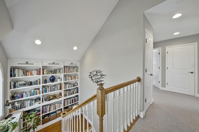 hallway with vaulted ceiling, carpet flooring, an upstairs landing, and recessed lighting