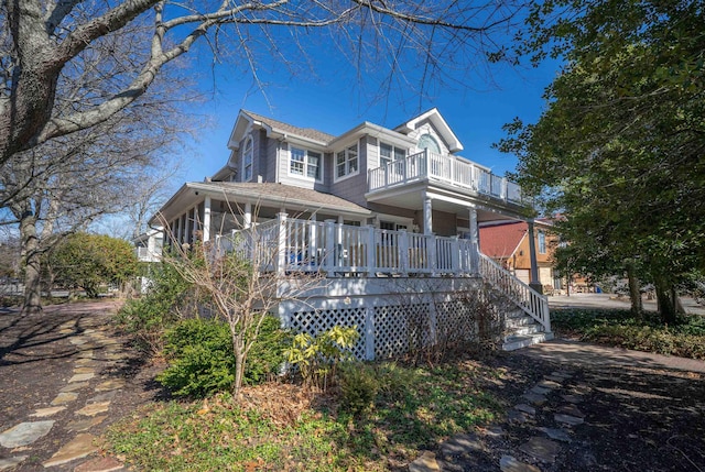 view of front of house featuring a sunroom and a balcony