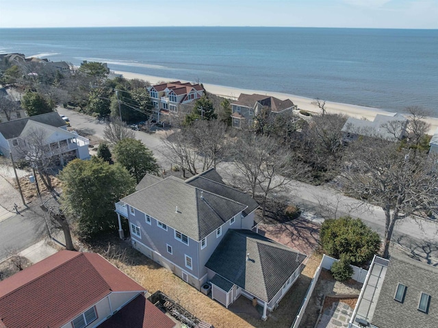 birds eye view of property with a water view and a beach view