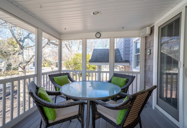 sunroom / solarium with a wall mounted AC and a wealth of natural light