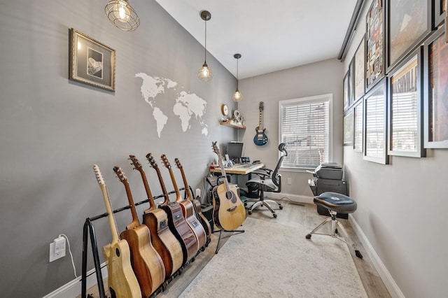 office area featuring baseboards and wood finished floors