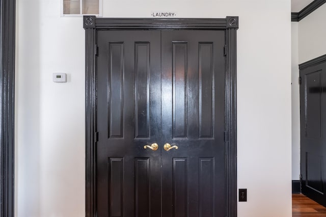 room details featuring hardwood / wood-style floors and crown molding