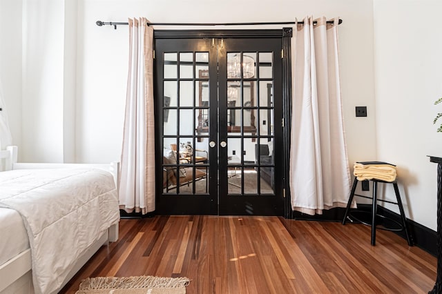 bedroom featuring dark wood-type flooring and french doors