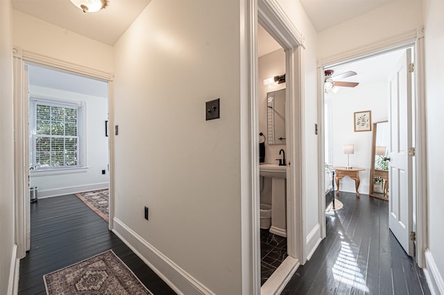 hallway featuring sink and dark hardwood / wood-style floors