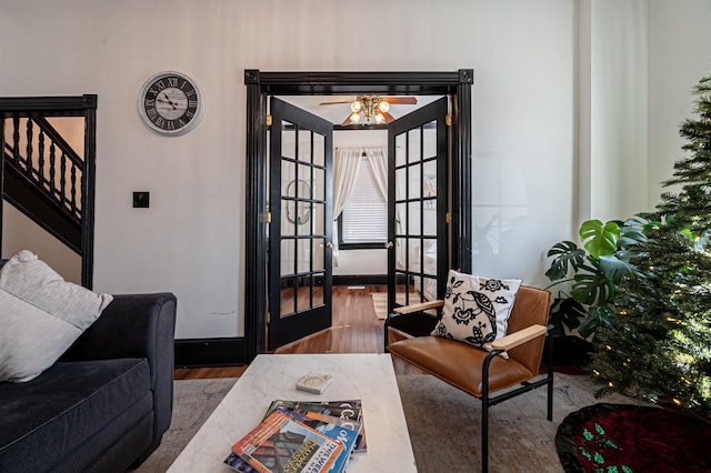 living room featuring dark hardwood / wood-style floors, ceiling fan, and french doors