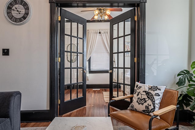 living area with ceiling fan, french doors, and hardwood / wood-style flooring