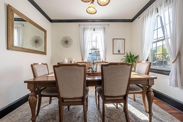 dining space with dark hardwood / wood-style flooring and ornamental molding