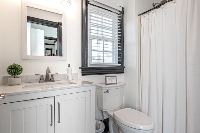 bathroom with plenty of natural light, vanity, and toilet