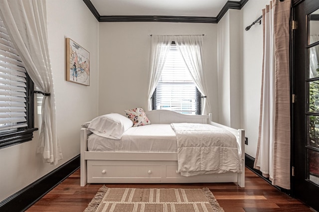 bedroom featuring dark hardwood / wood-style floors and crown molding