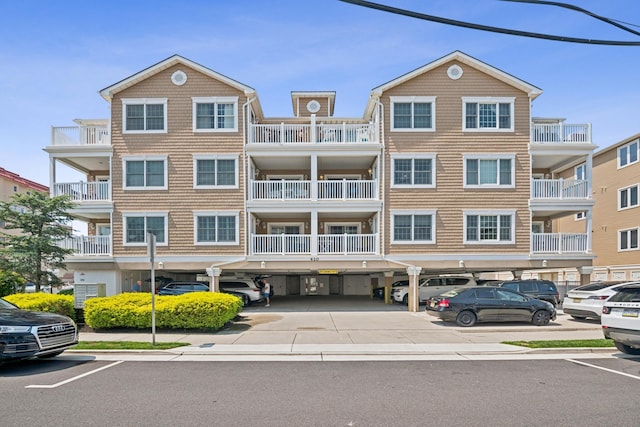 410 E Orchid Rd Unit 202, Wildwood Crest, NJ 08260 - view of building exterior featuring covered and uncovered parking