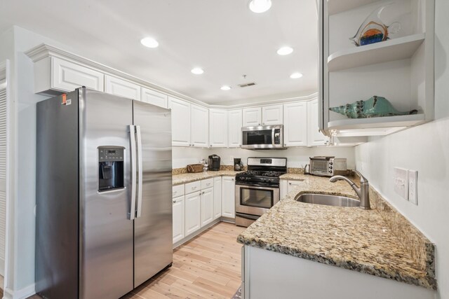 410 E Orchid Rd Unit 202, Wildwood Crest, NJ 08260 - kitchen with stainless steel appliances, open shelves, light wood-style floors, white cabinets, and recessed lighting