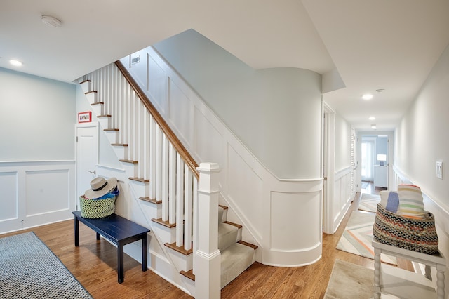 885 21st St W, Unit West, Avalon, NJ 08202 - stairs featuring a decorative wall, wood finished floors, wainscoting, and recessed lighting