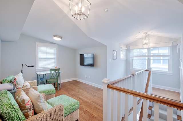 885 21st St W, Unit West, Avalon, NJ 08202 - living room featuring a chandelier, vaulted ceiling, and wood finished floors