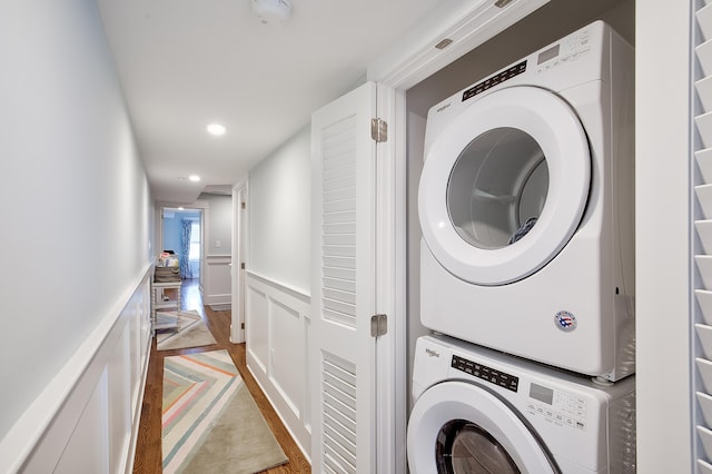 885 21st St W, Unit West, Avalon, NJ 08202 - laundry room featuring stacked washer / drying machine, a decorative wall, a wainscoted wall, recessed lighting, and wood finished floors