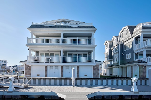 885 21st St W, Unit West, Avalon, NJ 08202 - view of front of home with a balcony, brick siding, and a boat dock