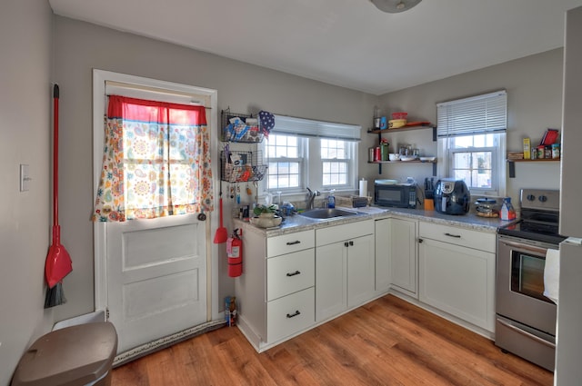 103 Bate Ave, Lower Township, NJ 08204 - kitchen featuring white cabinets, stainless steel electric range, light hardwood / wood-style flooring, and sink