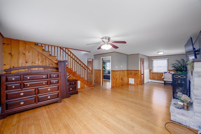 103 Bate Ave, Lower Township, NJ 08204 - living room with wooden walls, a fireplace, ceiling fan, light hardwood / wood-style flooring, and crown molding
