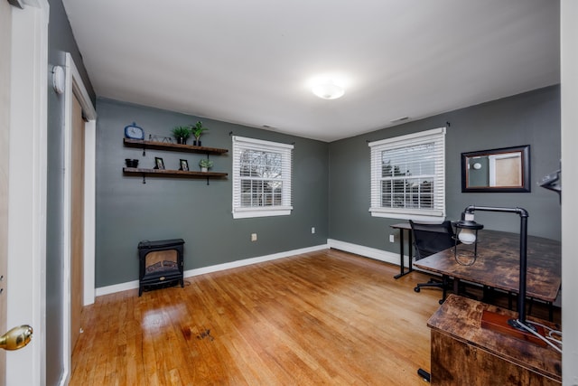 103 Bate Ave, Lower Township, NJ 08204 - office area with baseboard heating, hardwood / wood-style floors, and a wood stove