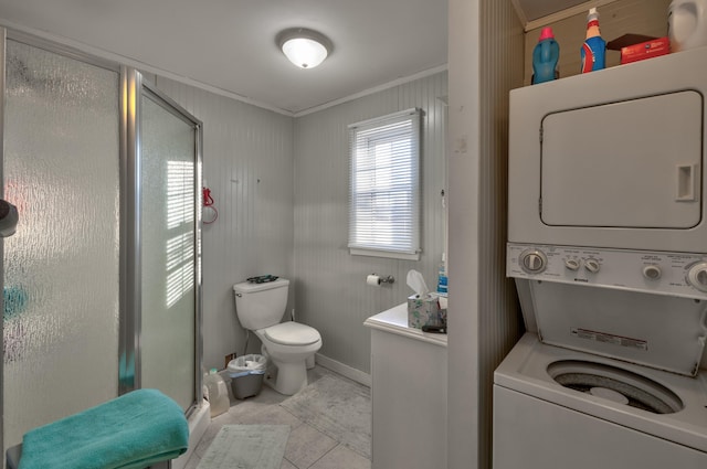 103 Bate Ave, Lower Township, NJ 08204 - bathroom with toilet, stacked washer and clothes dryer, tile patterned floors, a shower with door, and crown molding
