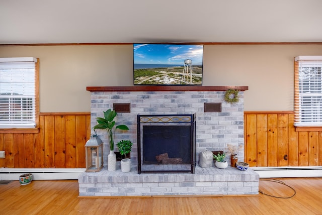 103 Bate Ave, Lower Township, NJ 08204 - details with baseboard heating, a brick fireplace, crown molding, and hardwood / wood-style flooring
