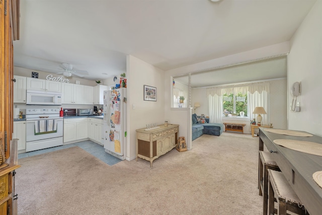 11 S 9th St, Del Haven, NJ 08251 - kitchen featuring white appliances, light carpet, a ceiling fan, and white cabinets