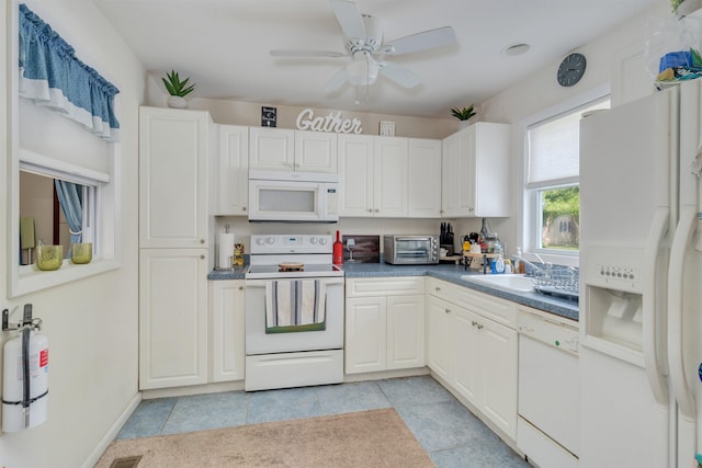 11 S 9th St, Del Haven, NJ 08251 - kitchen with white appliances, ceiling fan, light tile patterned flooring, and white cabinets