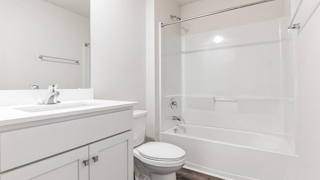 full bathroom featuring toilet, vanity,  shower combination, and hardwood / wood-style flooring