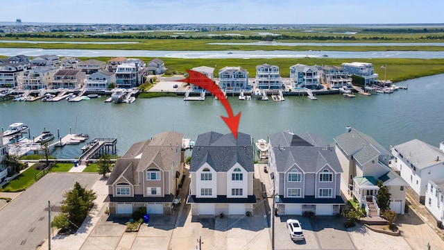 drone / aerial view featuring a water view and a residential view